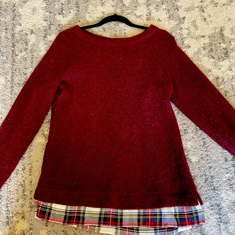 Sweater with plaid underlay at bottom